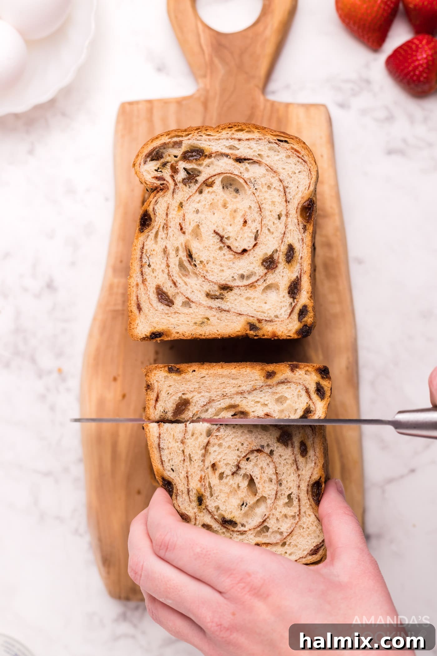 Cutting thick slices of bread into uniform 1-inch squares for Air Fryer French Toast Bites prep.