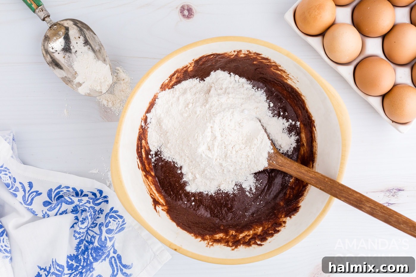 Adding flour into brownie mixture in a bowl