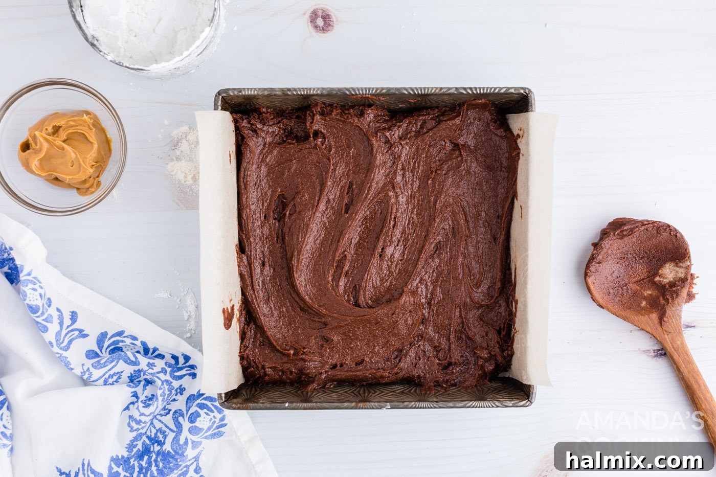 Brownie batter evenly spread in a prepared baking pan