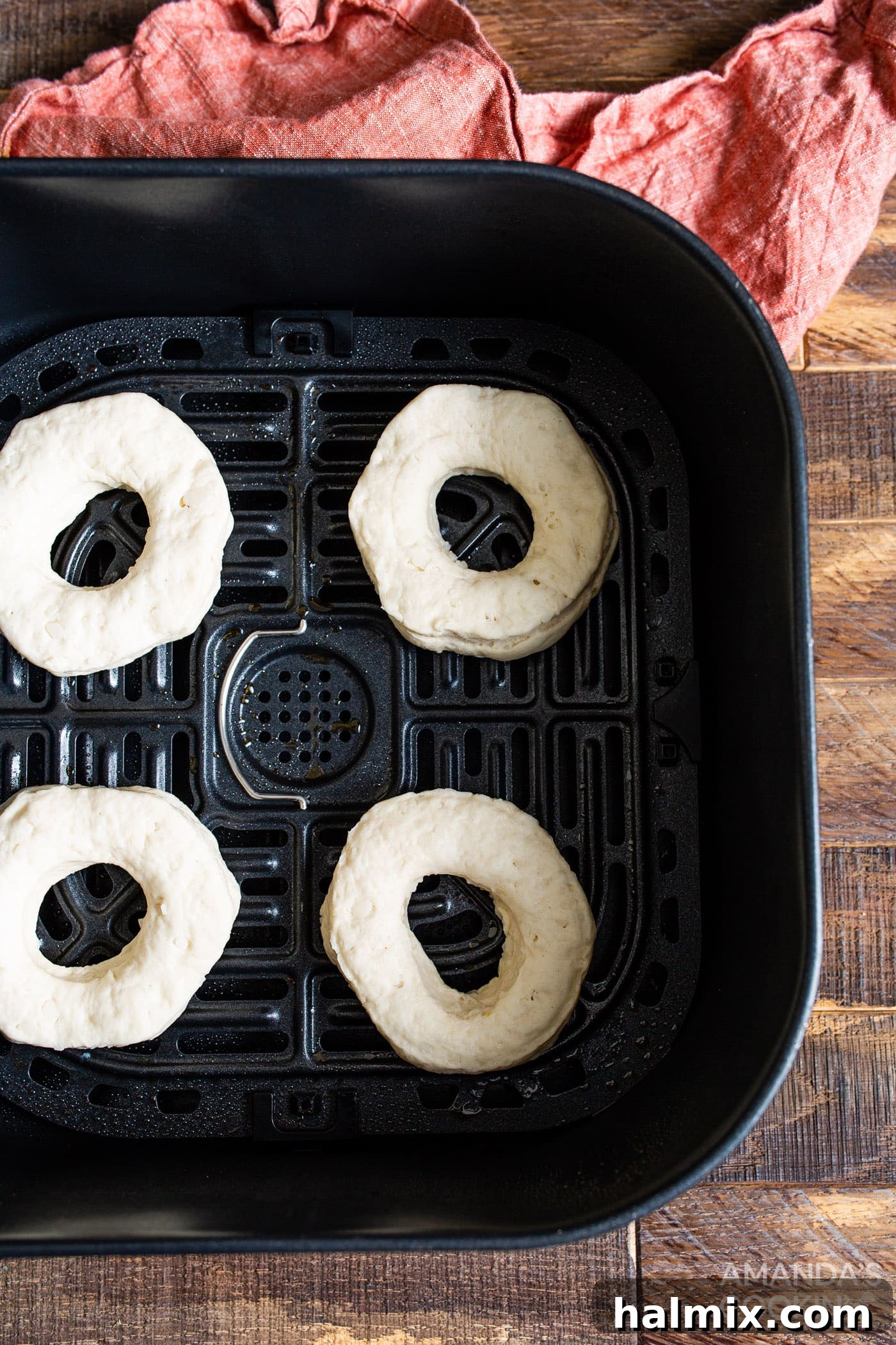 donuts and donut holes baking in an air fryer basket