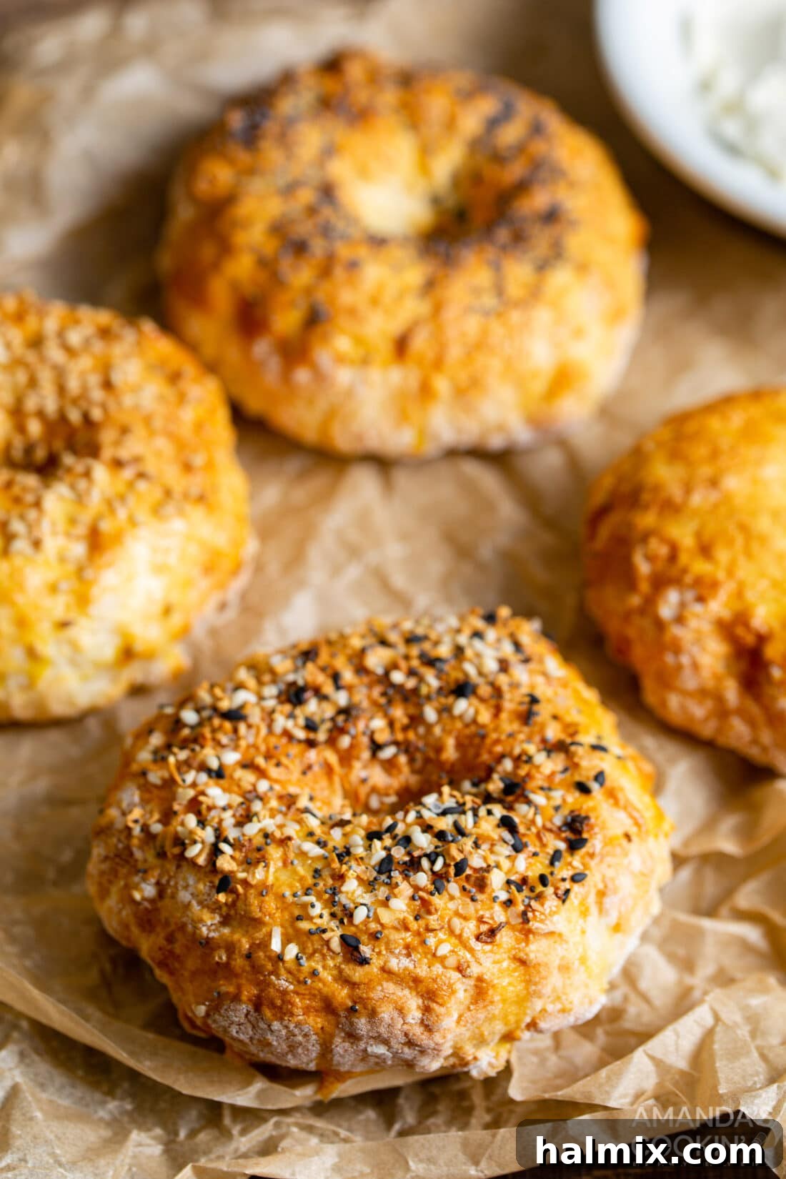 Golden brown air fryer bagels cooling on parchment paper, ready to be enjoyed.