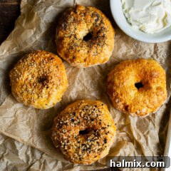 Homemade air fryer bagels cooling on parchment paper.