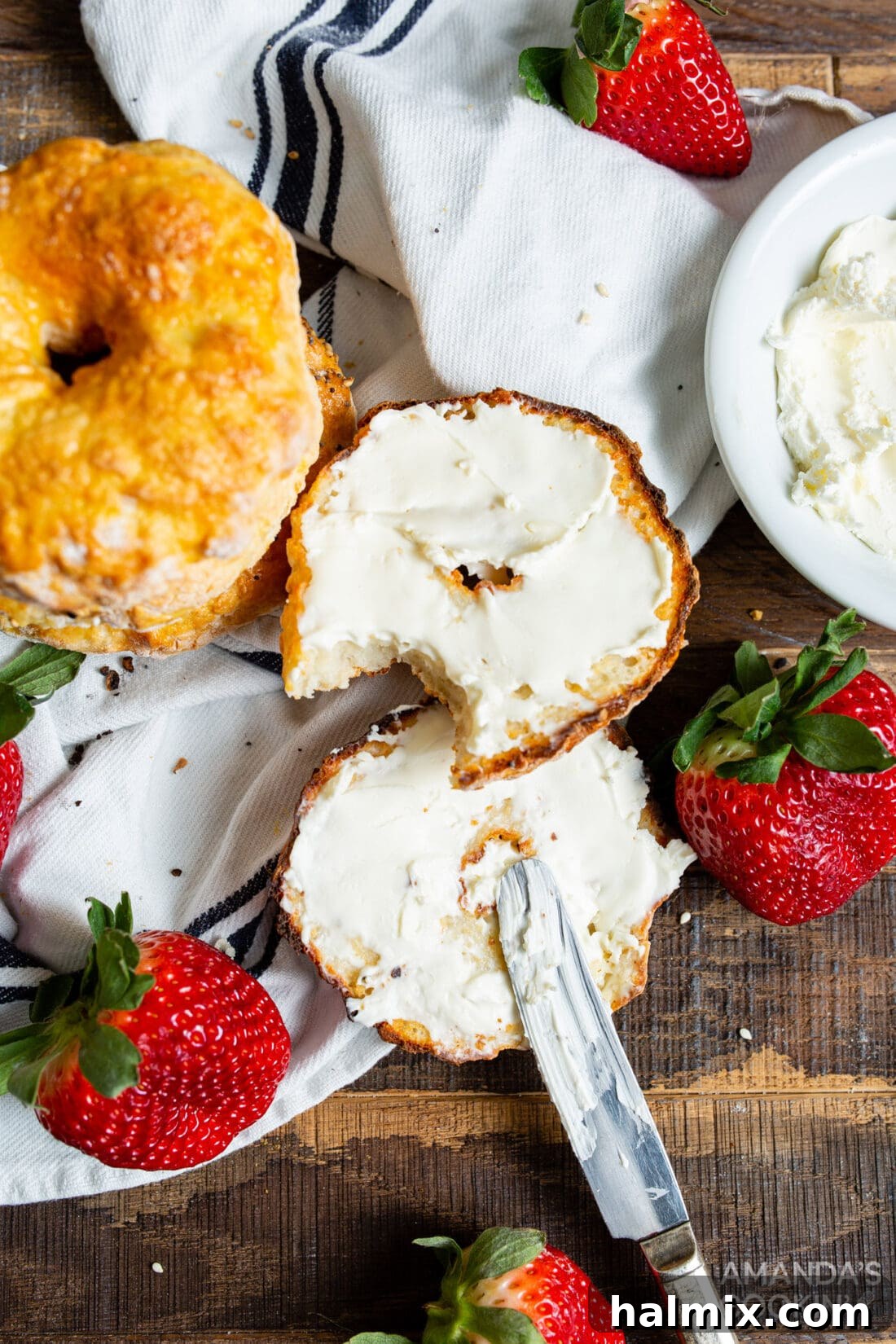 Delicious air fryer bagels topped with cream cheese and chives, ready to be enjoyed.