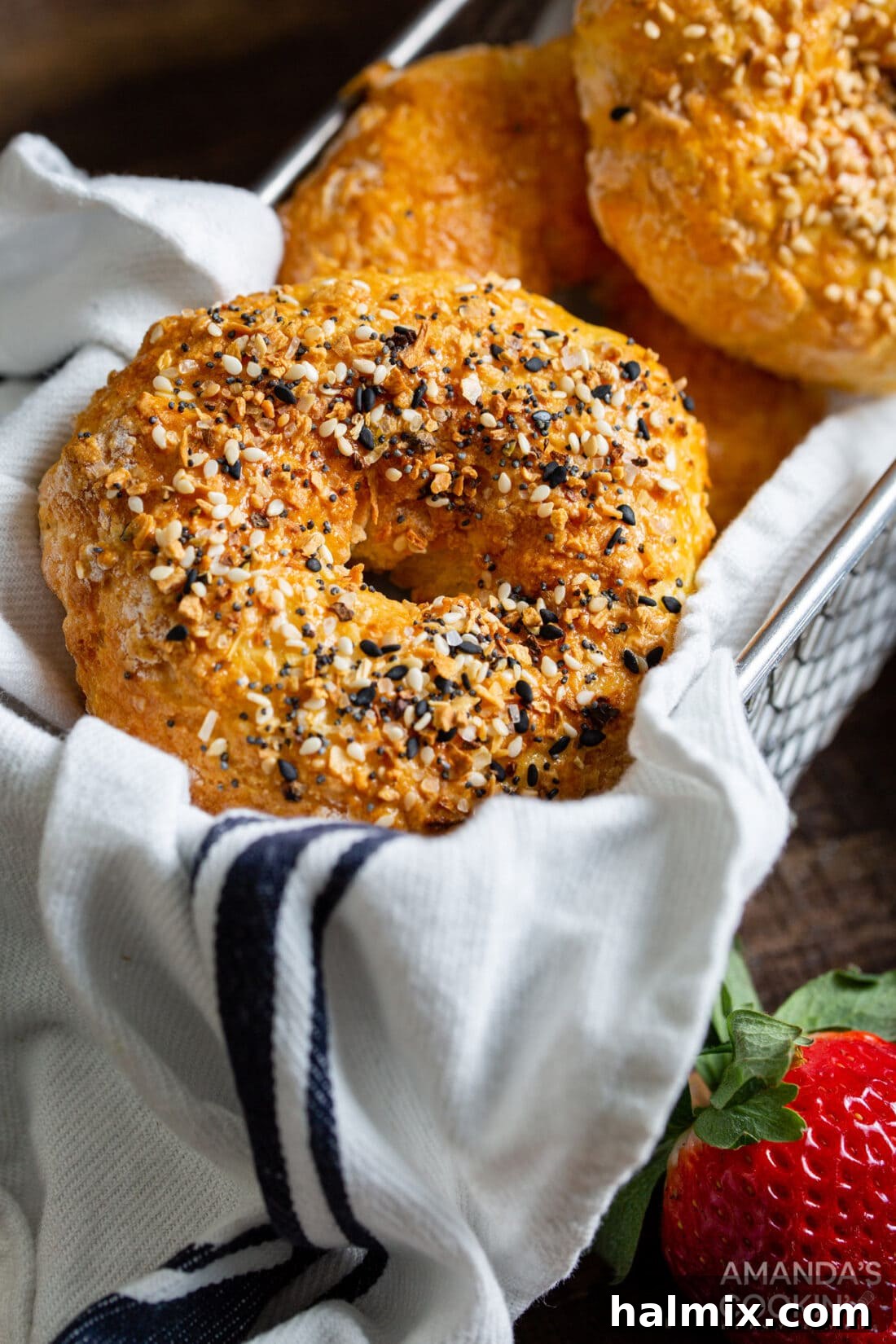 A charming basket filled with an assortment of freshly made air fryer bagels, featuring different toppings.