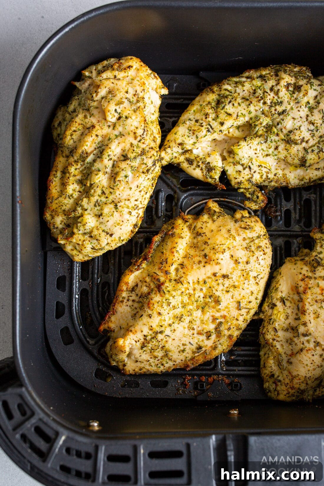 Juicy air fryer chicken breasts ready to serve with a garnish