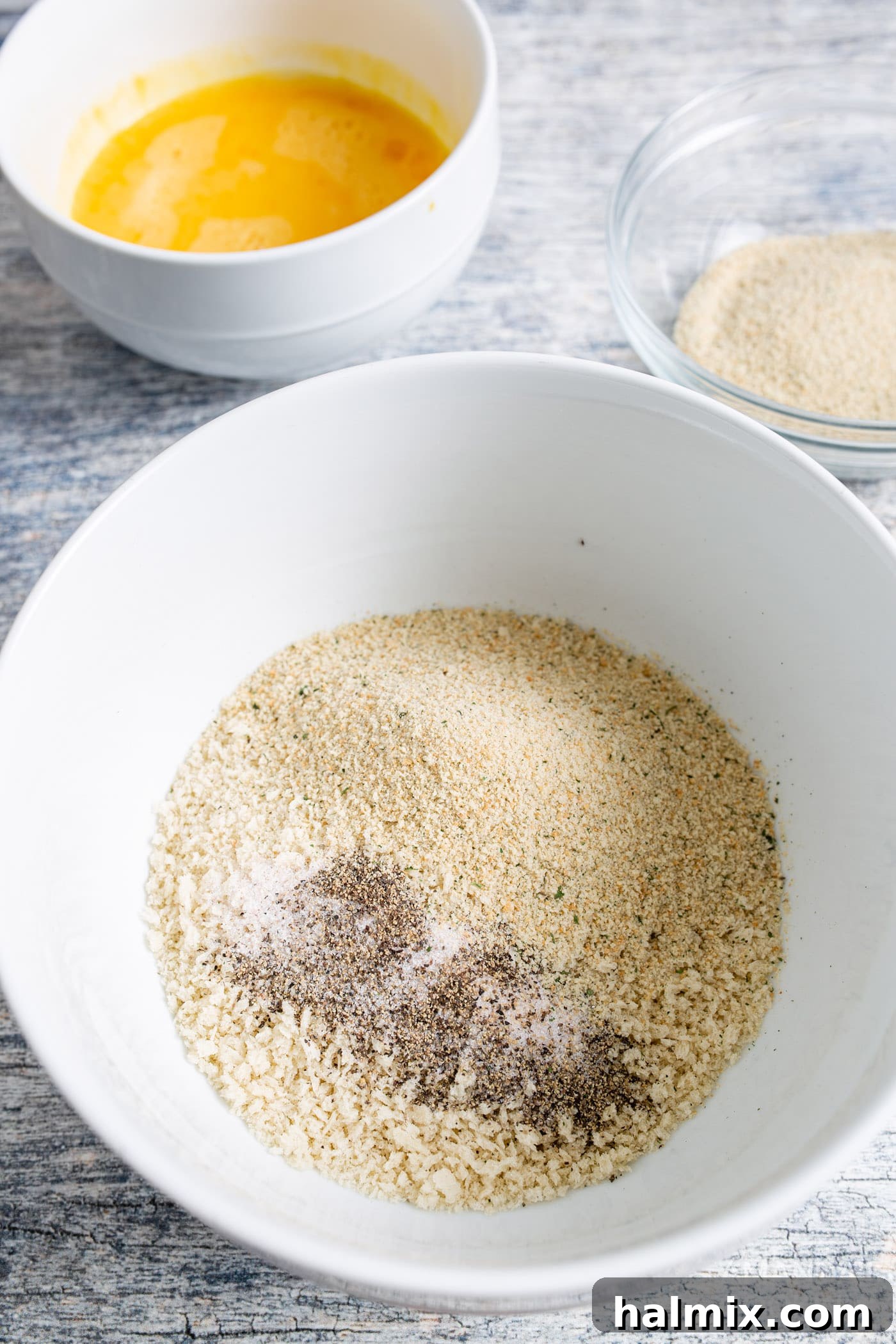 A bowl filled with a mixture of Panko and Italian breadcrumbs, seasoned with salt and pepper, ready for coating.