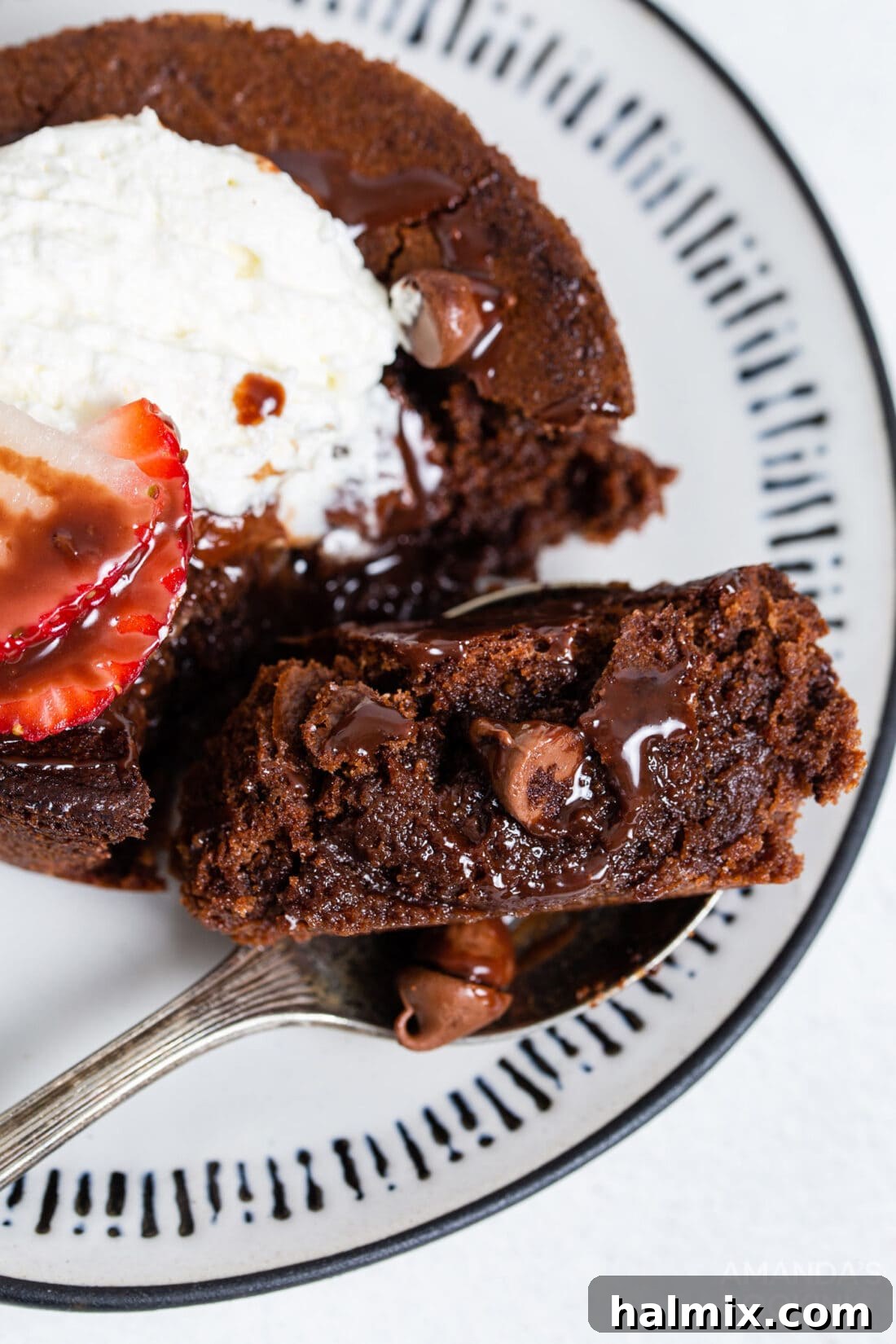 A fork holding a piece of moist, fudgy air fryer brownie, showcasing its dense and appealing texture.