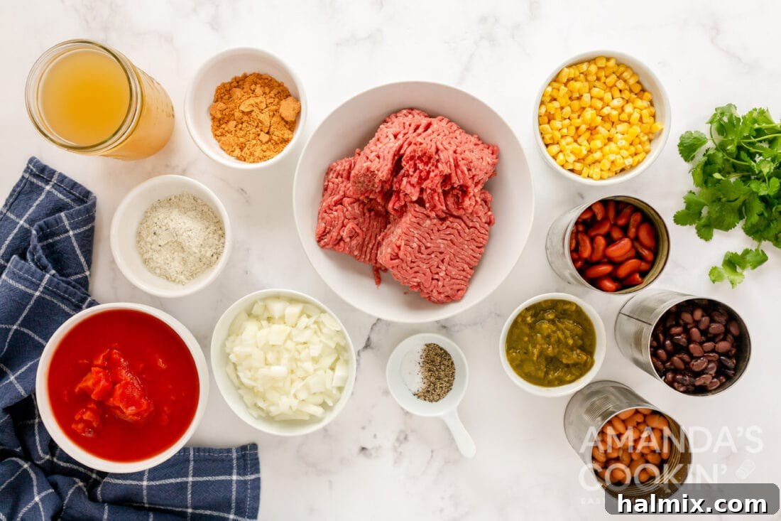 An array of fresh and canned ingredients neatly laid out on a wooden surface, ready for preparing taco soup.