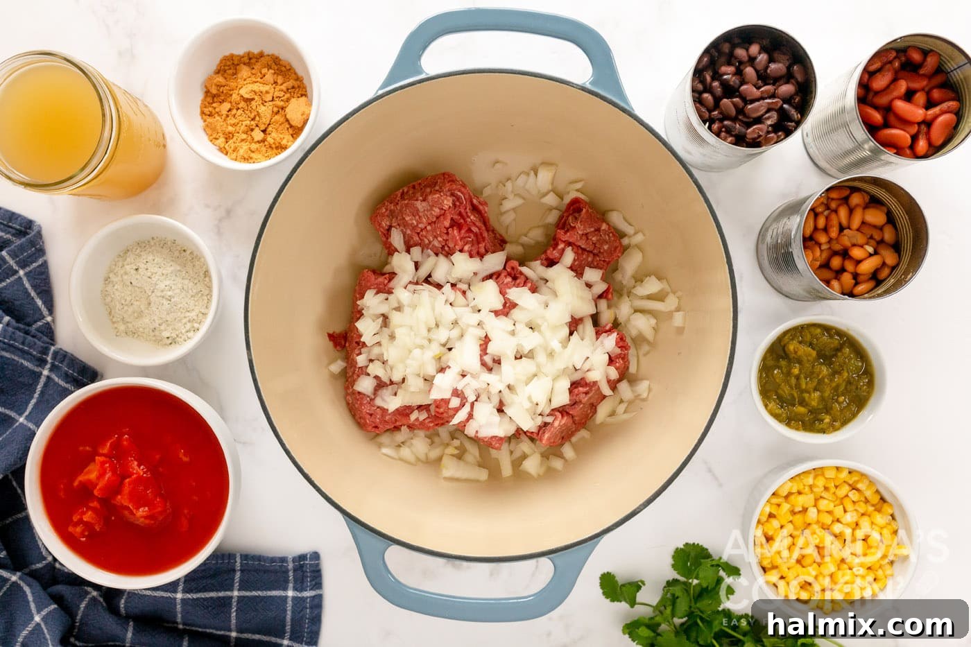 Ground beef and chopped onion cooking in a large Dutch oven, a crucial step for building flavor.