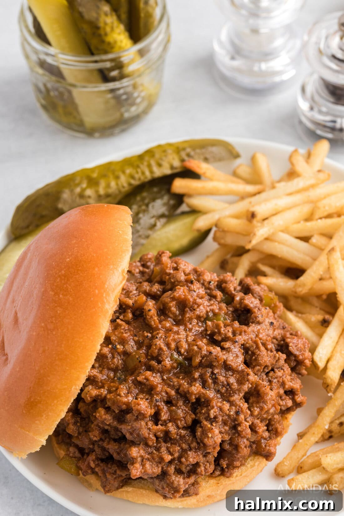 Messy Beef Bliss 3 Sloppy joes served on buns with a side of crispy french fries.