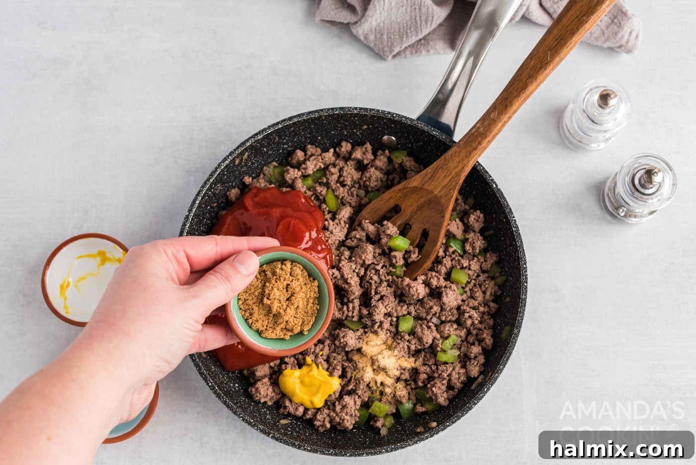Messy Beef Bliss 7 Adding ketchup, mustard, brown sugar, and garlic powder to the skillet with the cooked beef and vegetables.