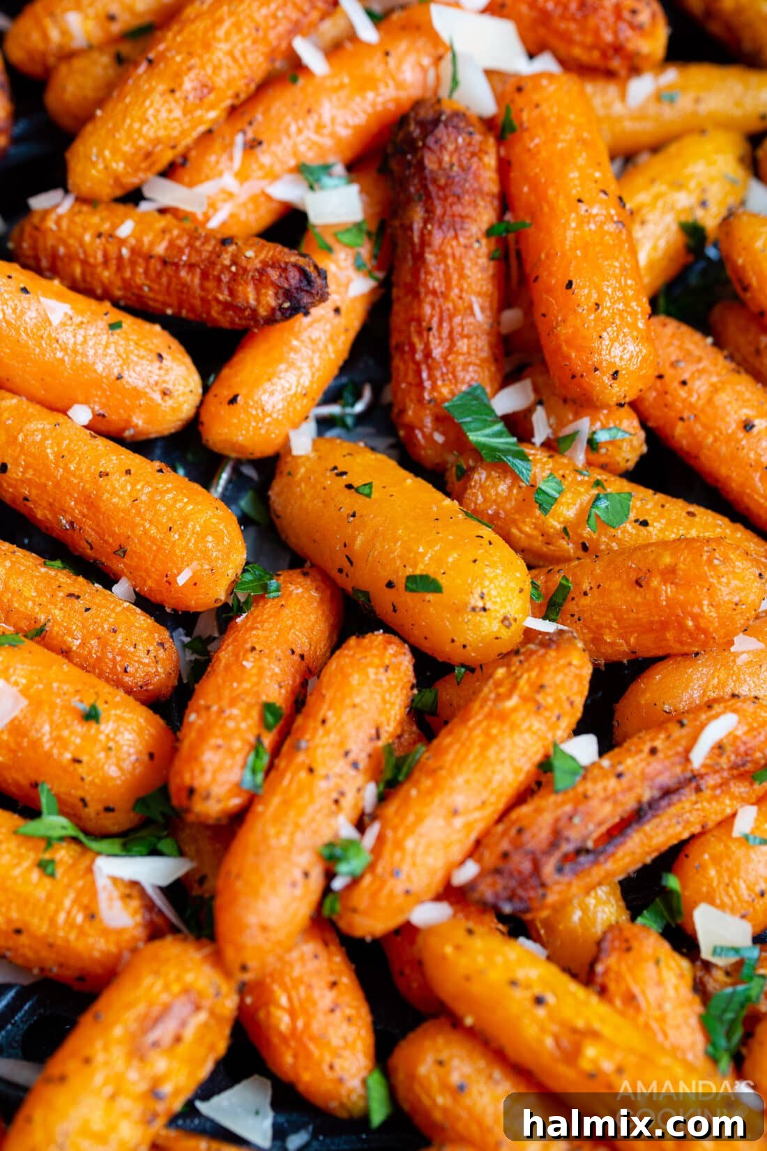 Crispy, golden-brown cooked carrots in an air fryer basket, ready to be served.