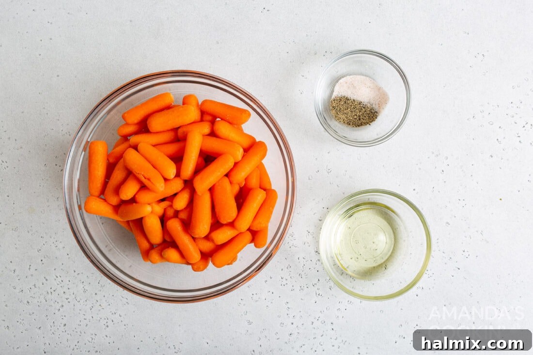 A simple arrangement of ingredients for making air fryer carrots, including fresh carrots, oil, salt, and pepper.