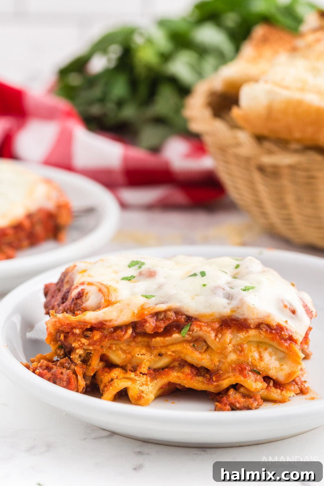 Effortless Slow Cooker Lasagna 12 A serving of rich, layered crockpot lasagna on a white plate, garnished with fresh parsley