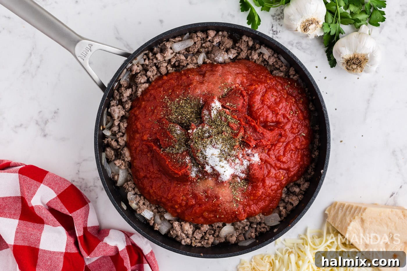 Tomato meat sauce simmering in a large skillet