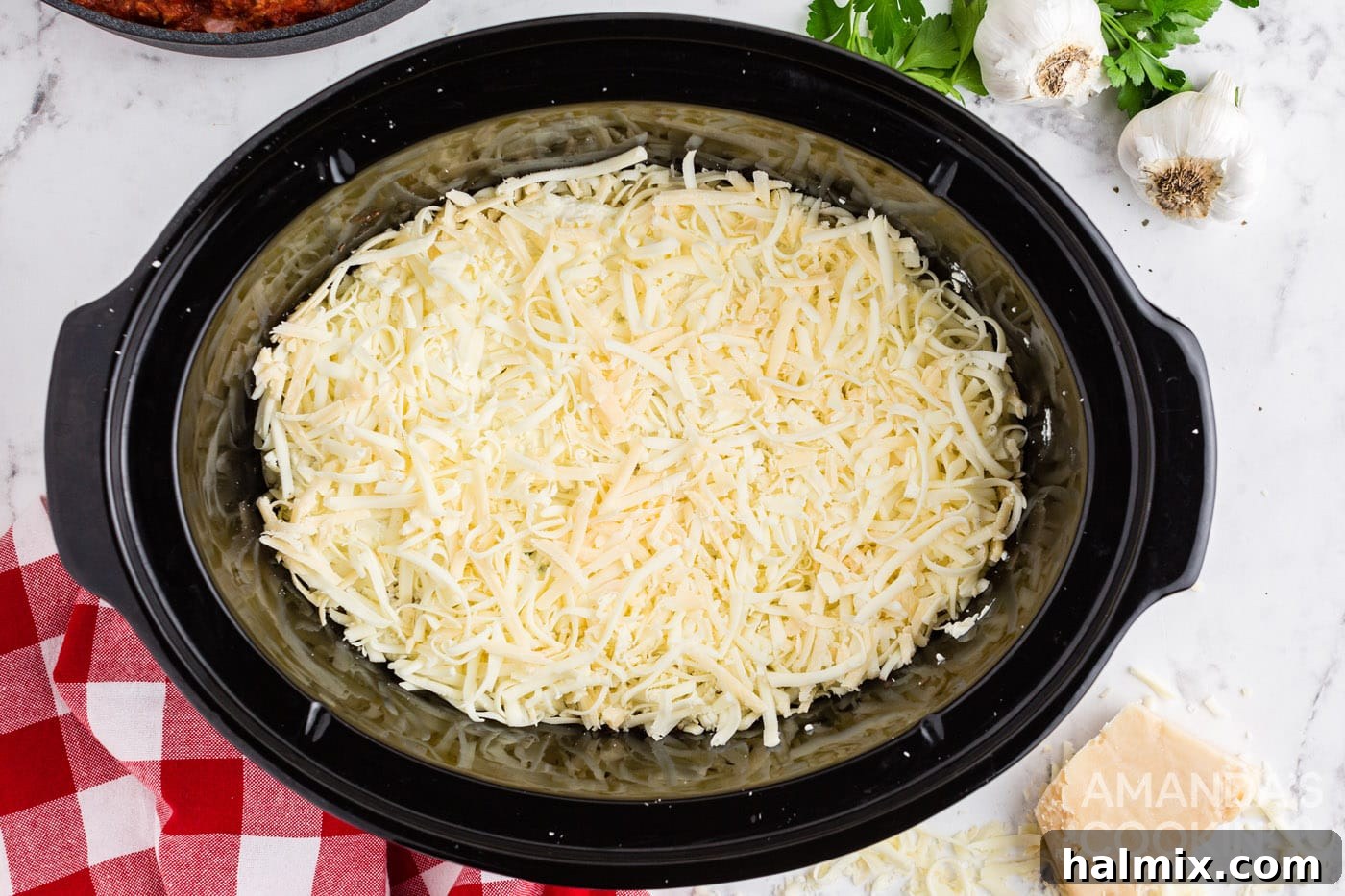 Layer of mozzarella cheese added to the lasagna in a crockpot