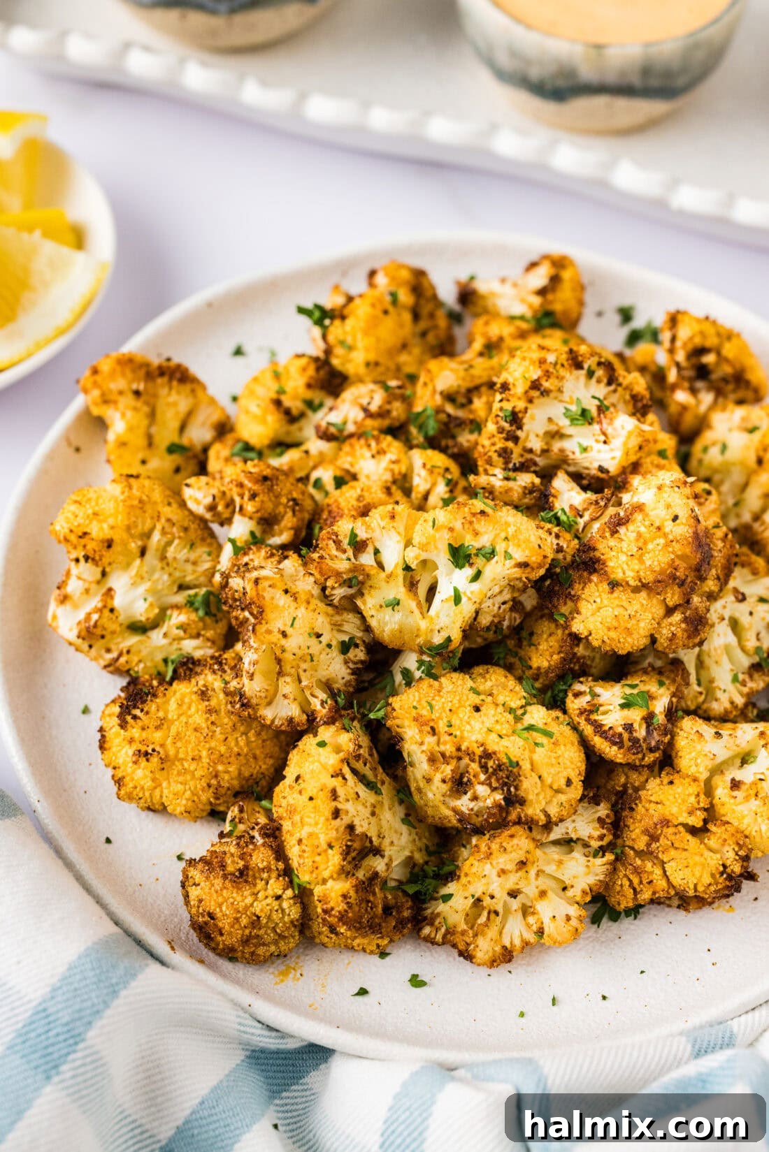 Golden Crispy Air Fryer Cauliflower 3 Close up photo of Air Fryer Cauliflower on a plate