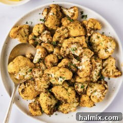 Plate of Air Fryer Cauliflower with a serving spoon on the side