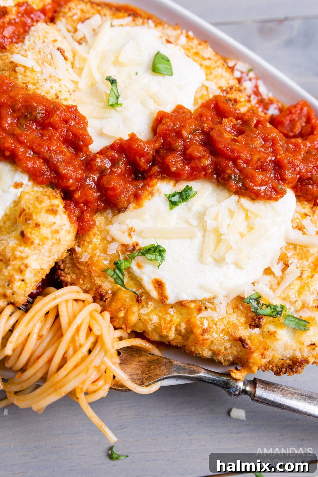 Crispy Air Fryer Chicken Parmesan 12 Air fryer chicken parmesan served on a plate with pasta in marinara sauce