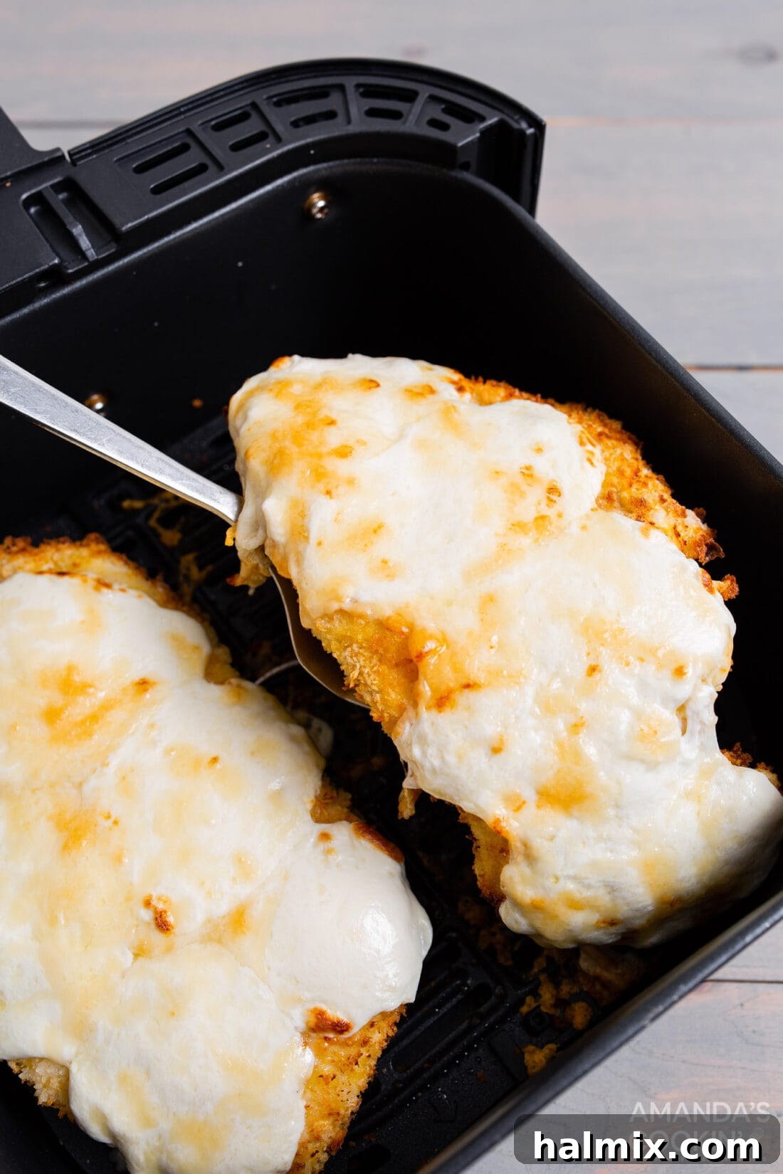 Crispy Air Fryer Chicken Parmesan 3 Removing perfectly cooked chicken parmesan from an air fryer basket