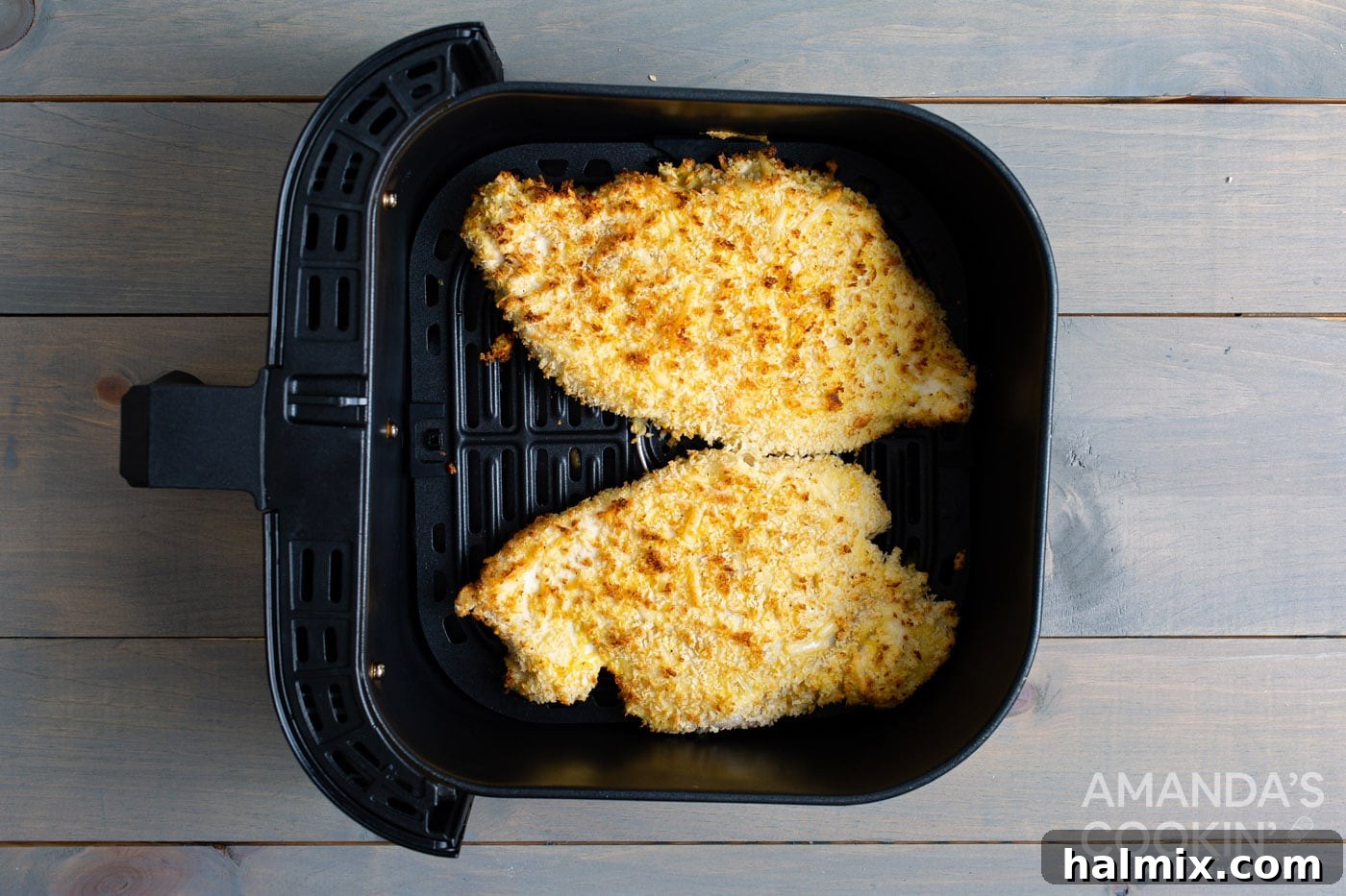 Crispy Air Fryer Chicken Parmesan 9 Two chicken breasts cooking in the air fryer