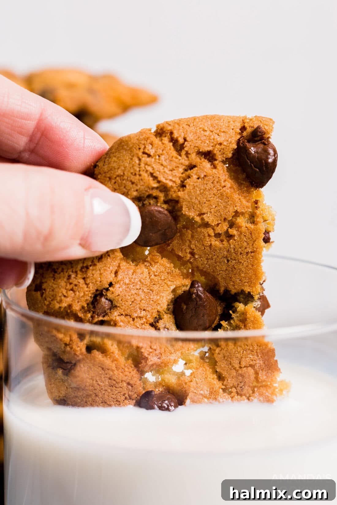 dipping air fryer chocolate chip cookie in milk