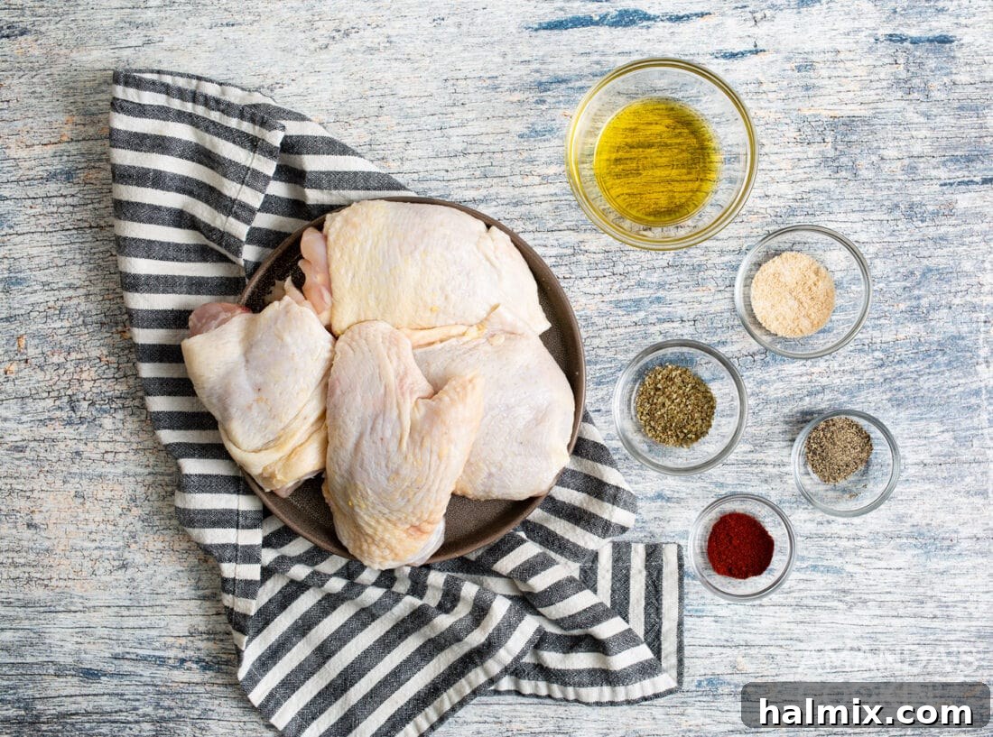 Golden Crispy Air Fryer Thighs 4 a flat lay showing all the ingredients needed for air fryer chicken thighs including chicken, olive oil, and various spices