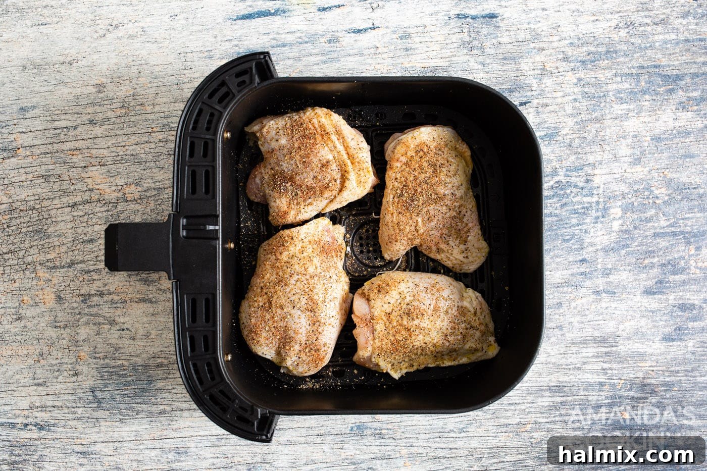 Golden Crispy Air Fryer Thighs 7 chicken thighs placed skin side down in an air fryer basket, ready for cooking