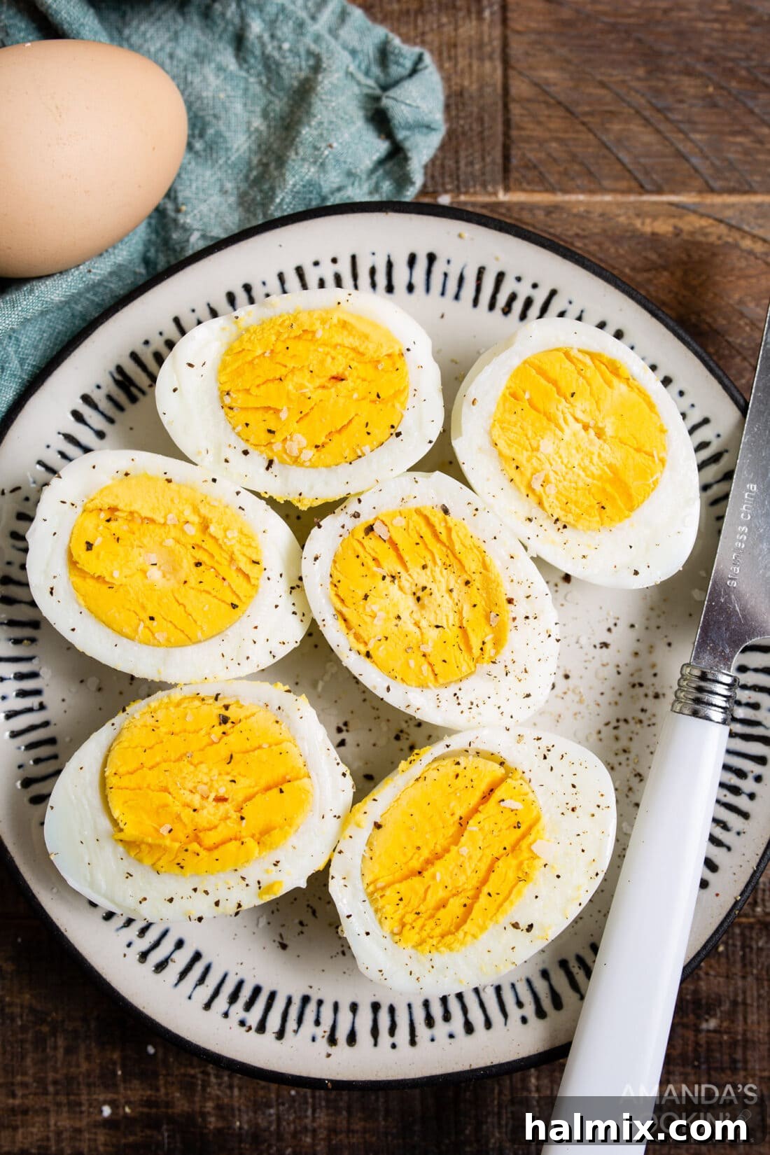halved hard boiled eggs on a plate, showcasing a perfect yolk