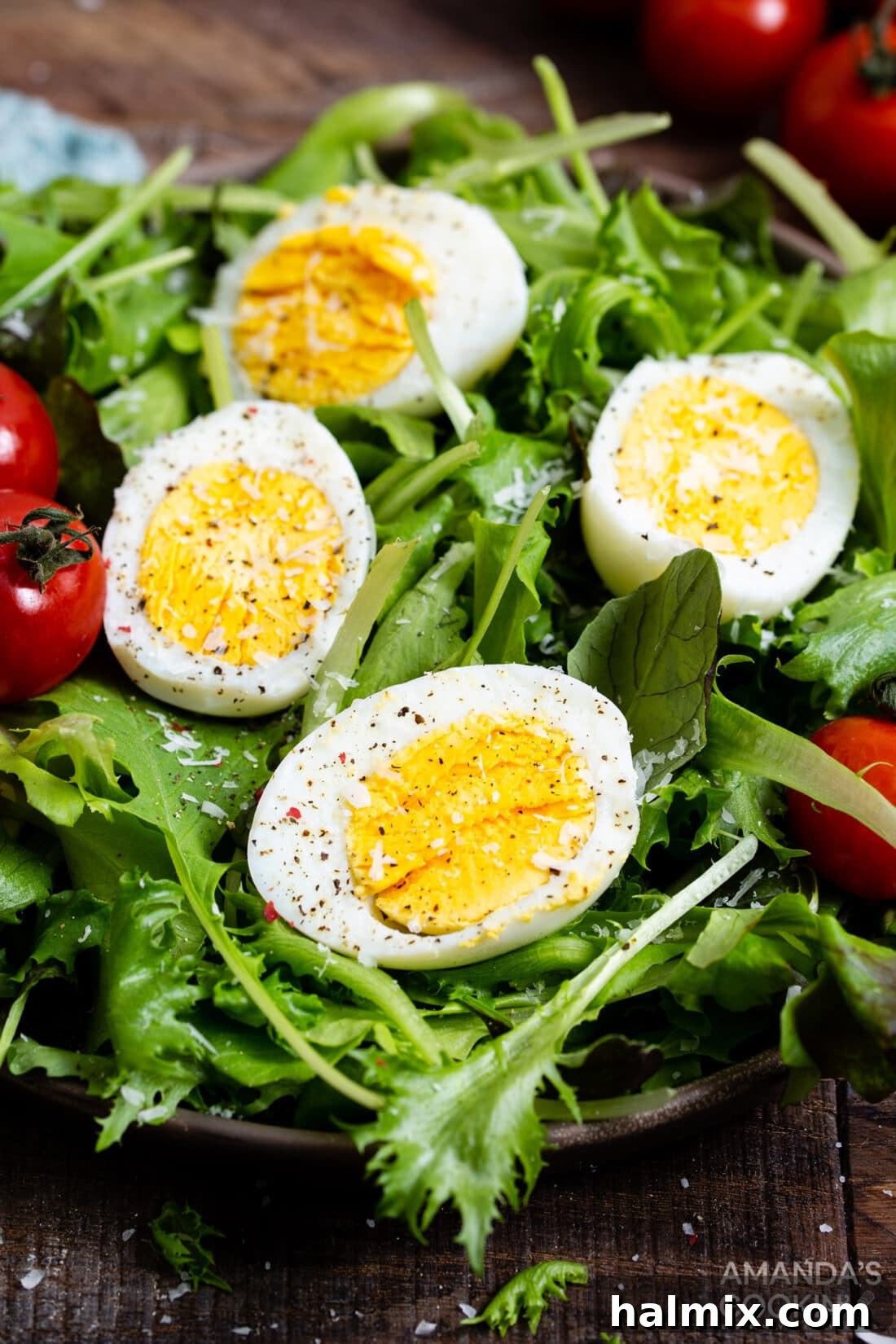 sliced hard boiled eggs on a vibrant green salad