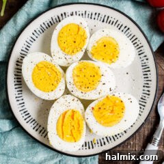 halved air fryer hard boiled eggs on a plate, showcasing a perfect yolk