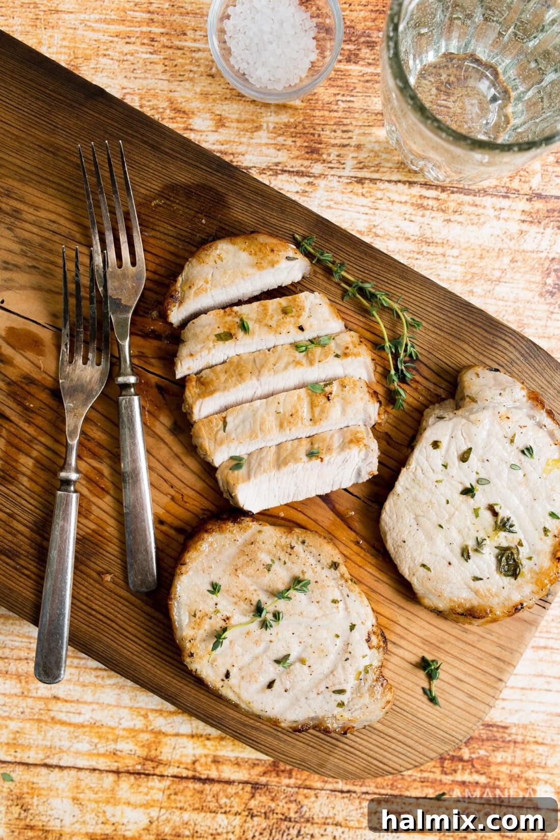 Perfectly cooked, juicy pork chops on a cutting board, ready to be served