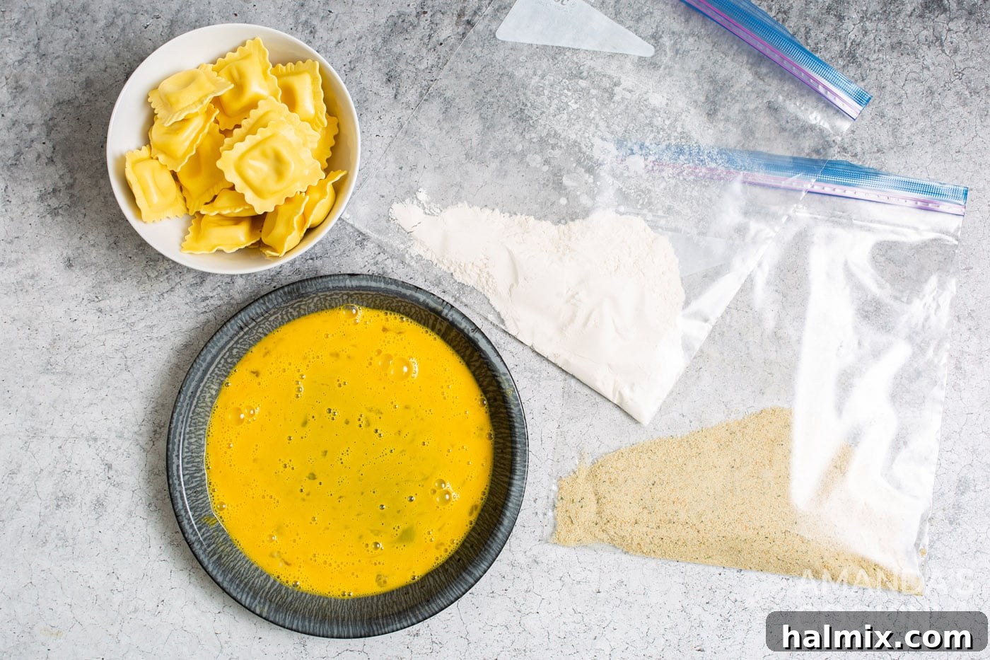 Flour in one Ziploc bag, Italian seasoned breadcrumbs in another, and beaten eggs in a pie plate, ready for the dipping station.