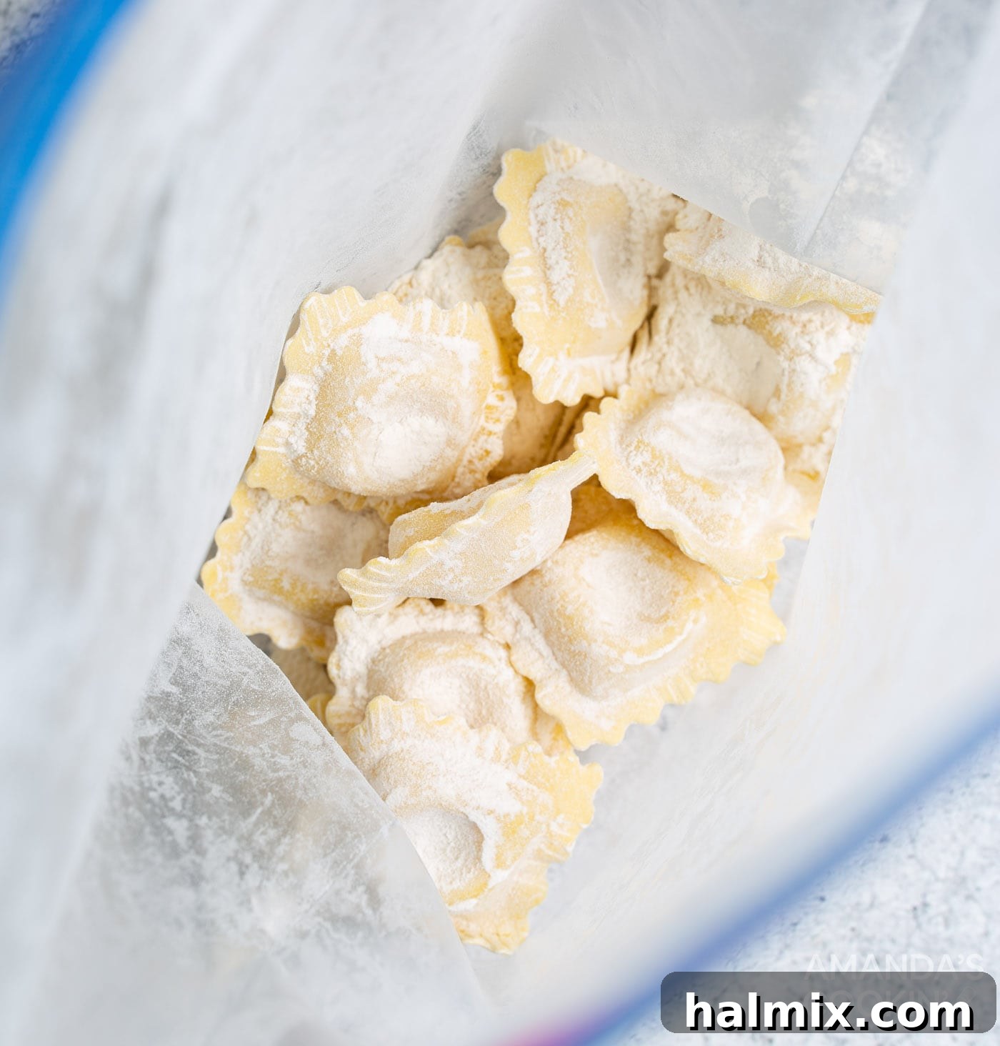 Ravioli being shaken in a Ziploc bag filled with all-purpose flour for the first coating.