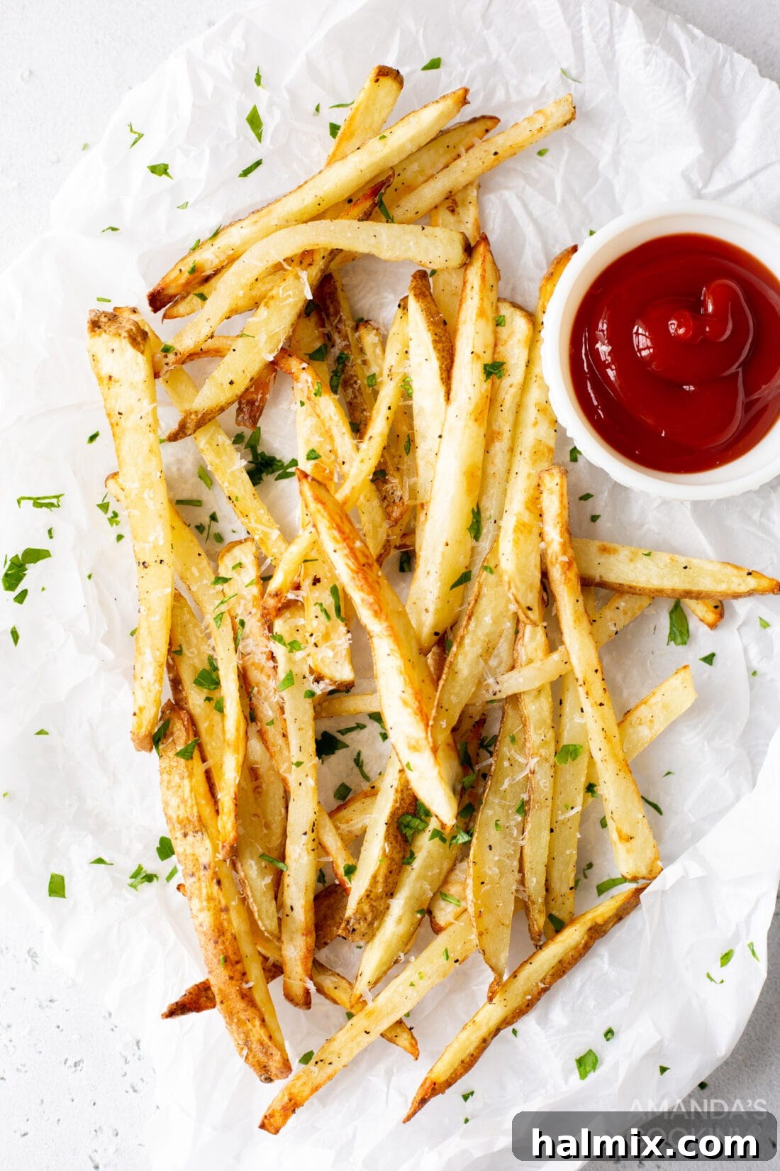 Crispy Golden Air Fryer Fries 2 Crispy air fryer french fries served on a plate with a side of vibrant red ketchup, showcasing their golden-brown perfection.