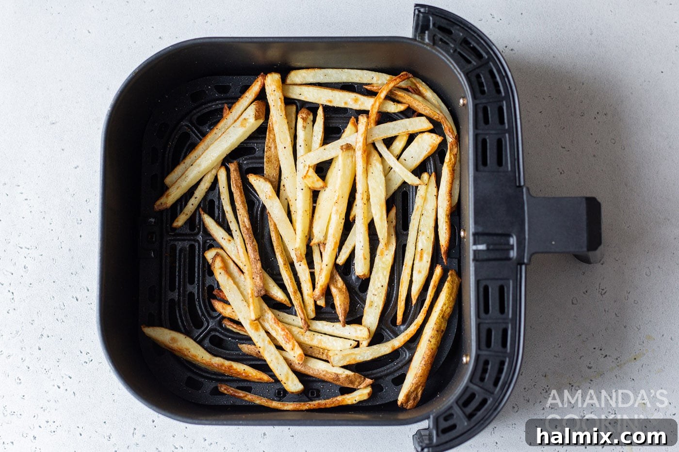 Crispy Golden Air Fryer Fries 8 Perfectly cooked, golden-brown air fryer french fries inside the air fryer basket, ready to be served.
