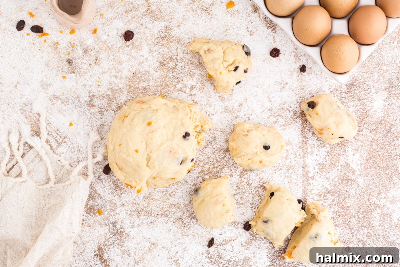 Spiced Easter Delights 13 Divided dough pieces resting on a lightly floured surface