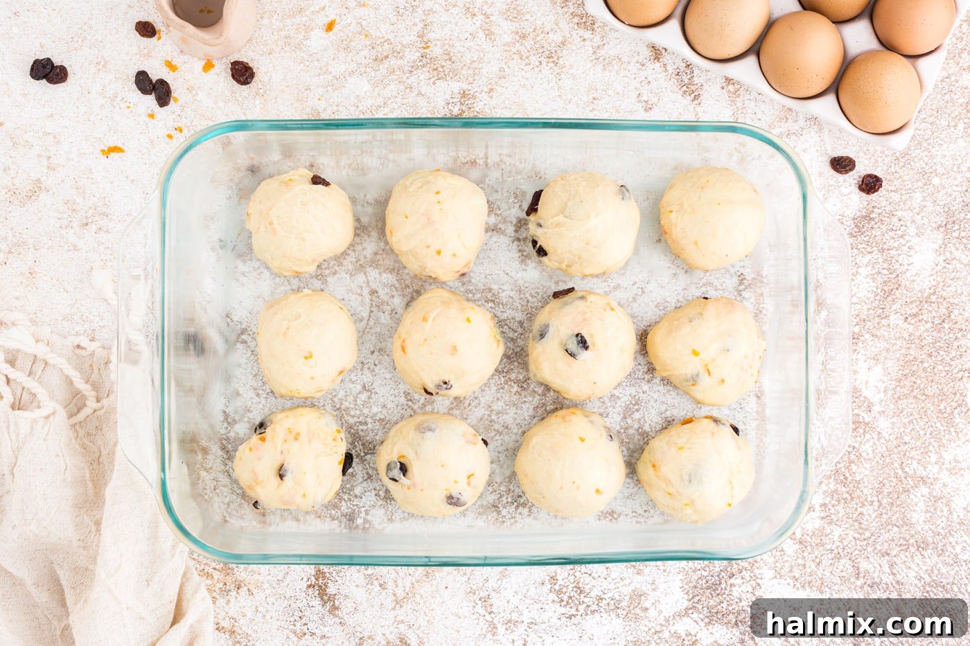 Spiced Easter Delights 14 Shaped dough balls arranged in a greased baking dish