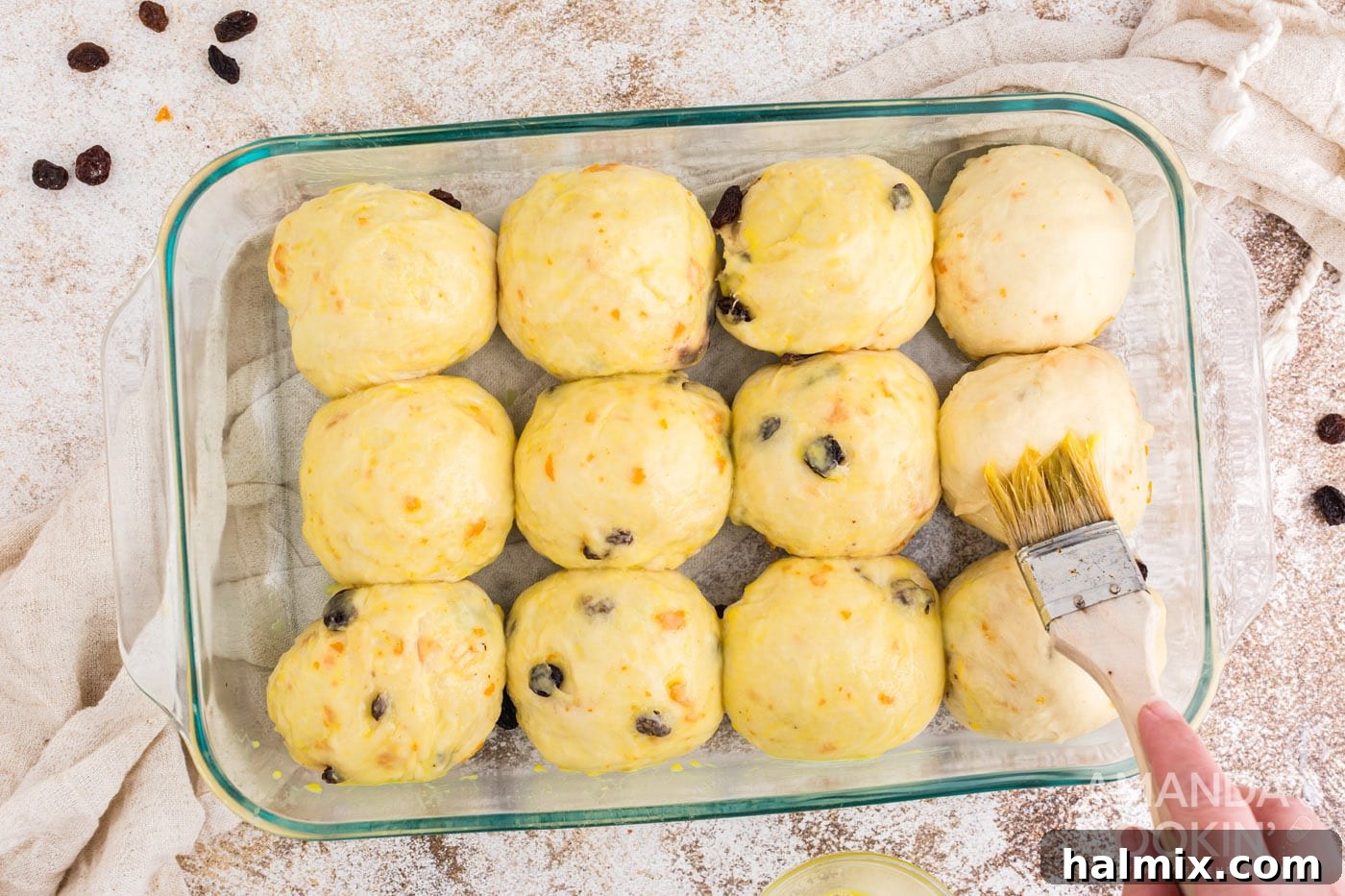 Spiced Easter Delights 16 Brushing the tops of dough balls with egg wash before baking