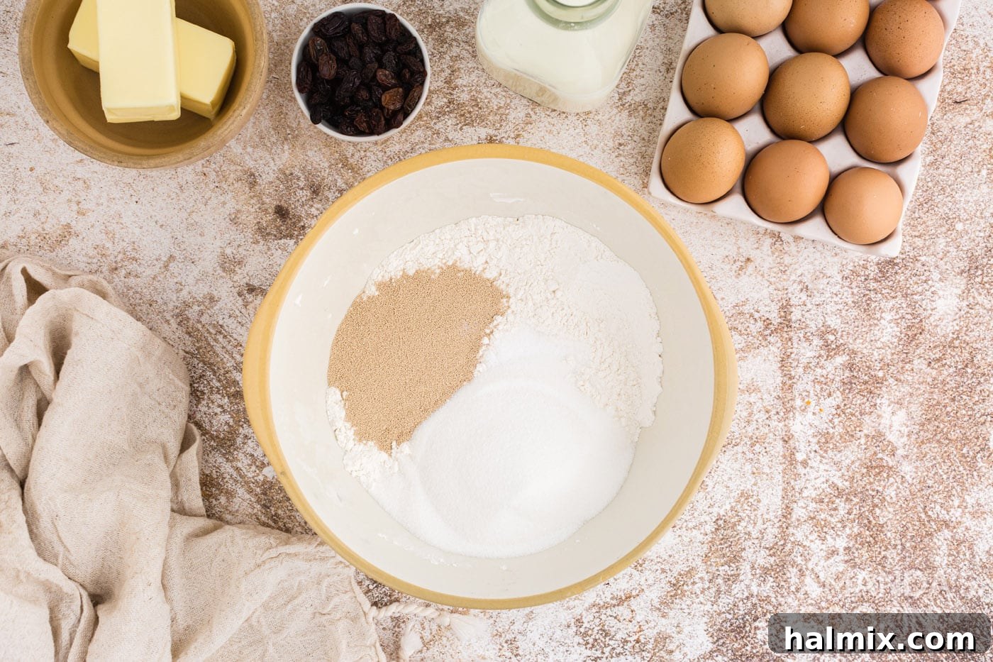 Spiced Easter Delights 5 Sugar, yeast, and flour combined in a large mixing bowl
