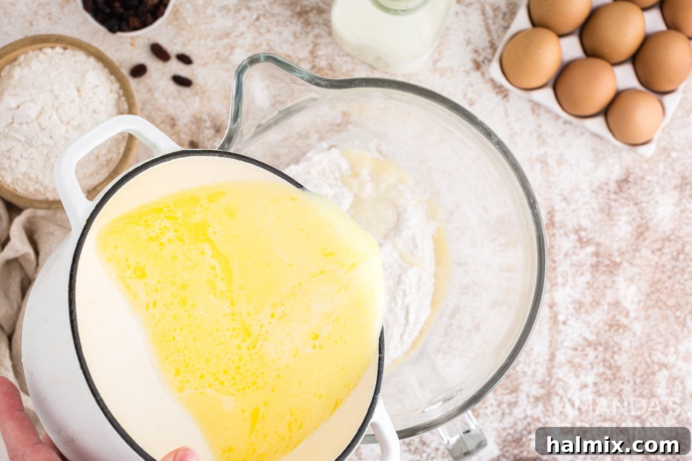 Spiced Easter Delights 7 Slowly adding wet ingredients to dry ingredients in a mixer bowl