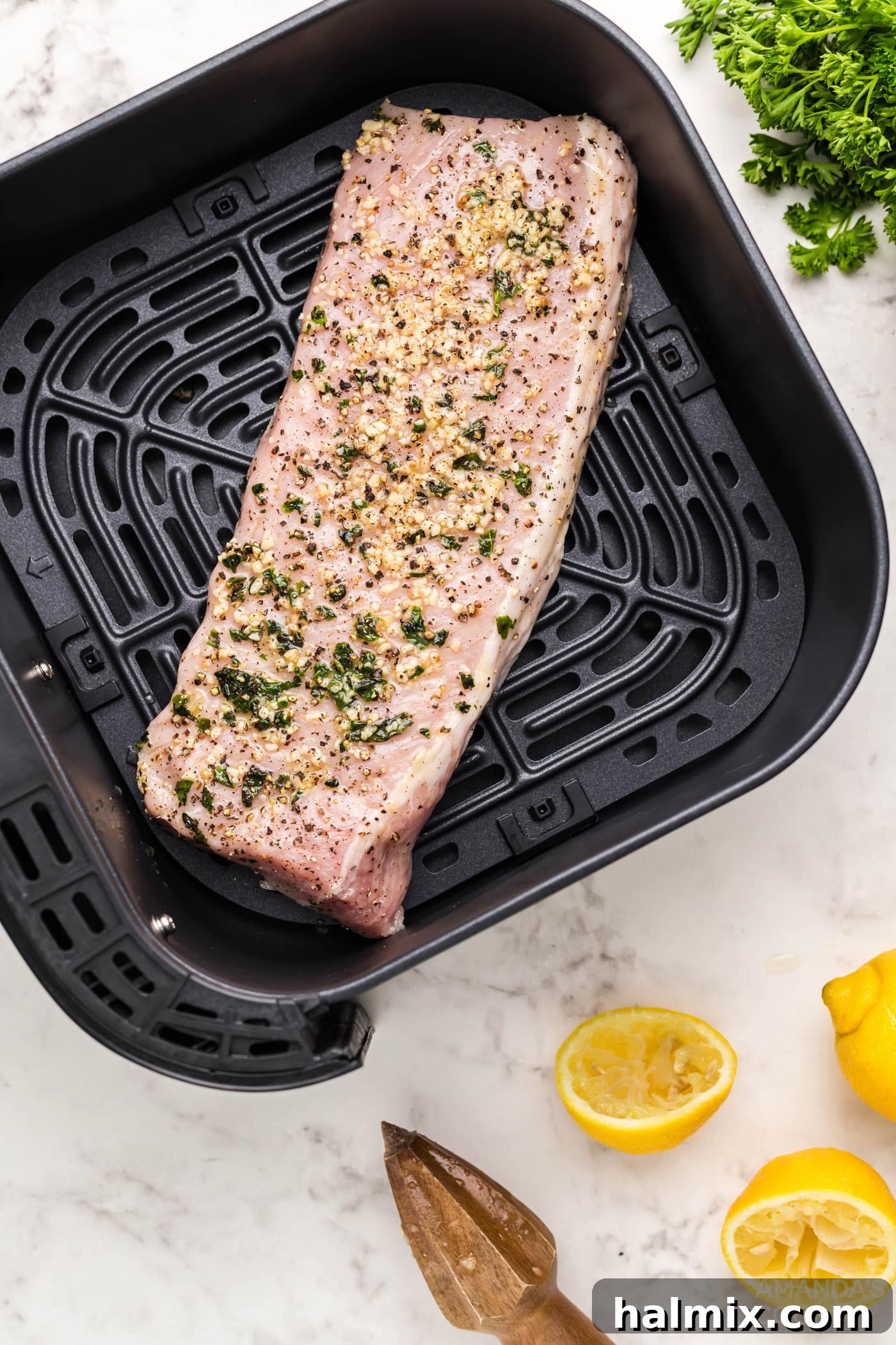 pork tenderloin meat on air fryer grate