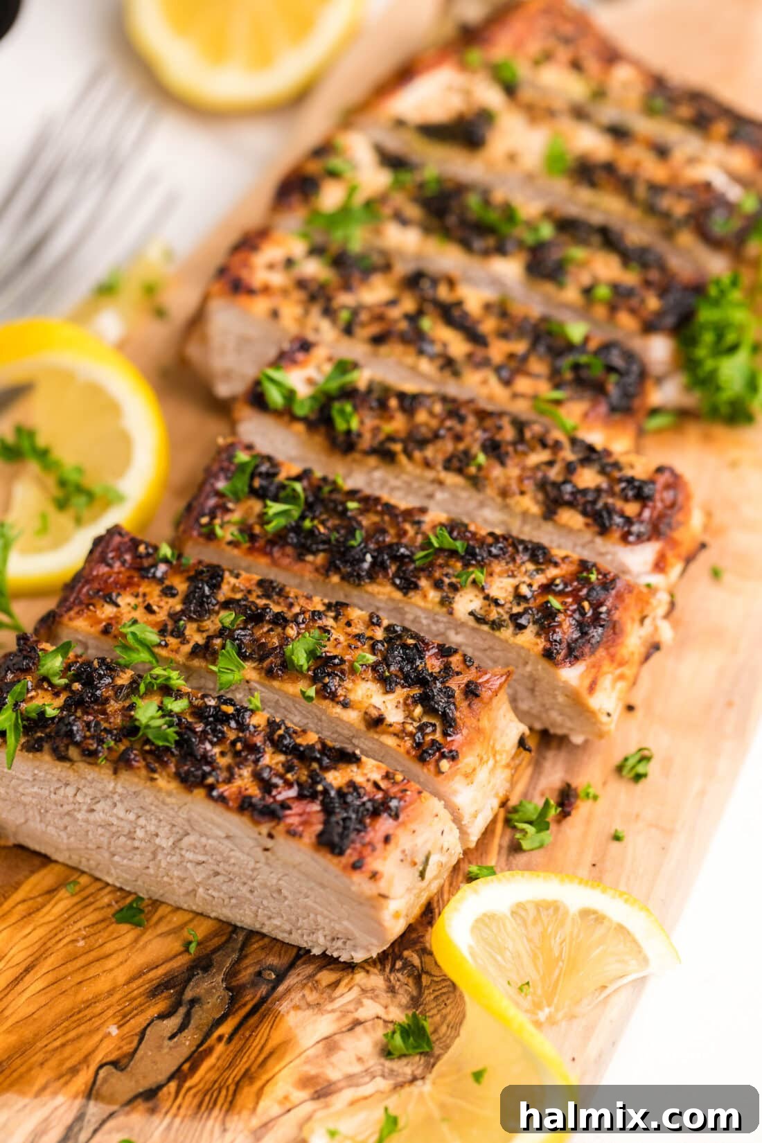 sliced Air Fryer Pork Tenderloin on a cutting board