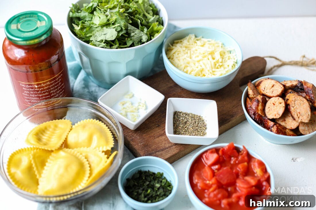 Fresh ingredients laid out for making Ravioli Lasagna, including ravioli, marinara, cheese, spinach, and sausage.