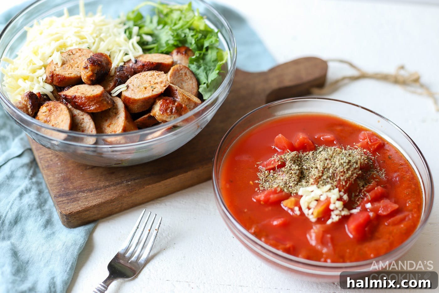 Two bowls: one with marinara, diced tomatoes, garlic, and Italian seasoning for the sauce, and another with chopped kale, cooked sausage, cheese, and basil for the filling.