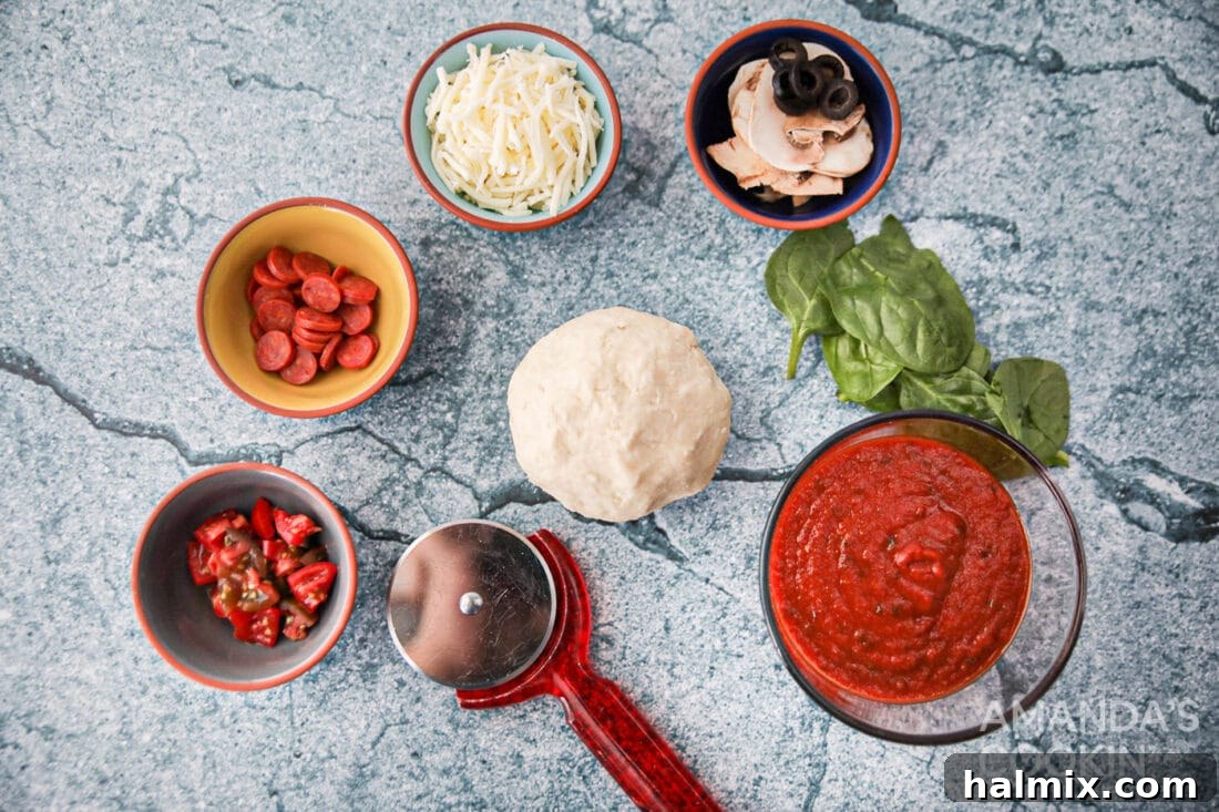 Ingredients for making Air Fryer Pizza including store-bought dough, jarred sauce, shredded mozzarella, and various fresh toppings like pepperoni and bell peppers.