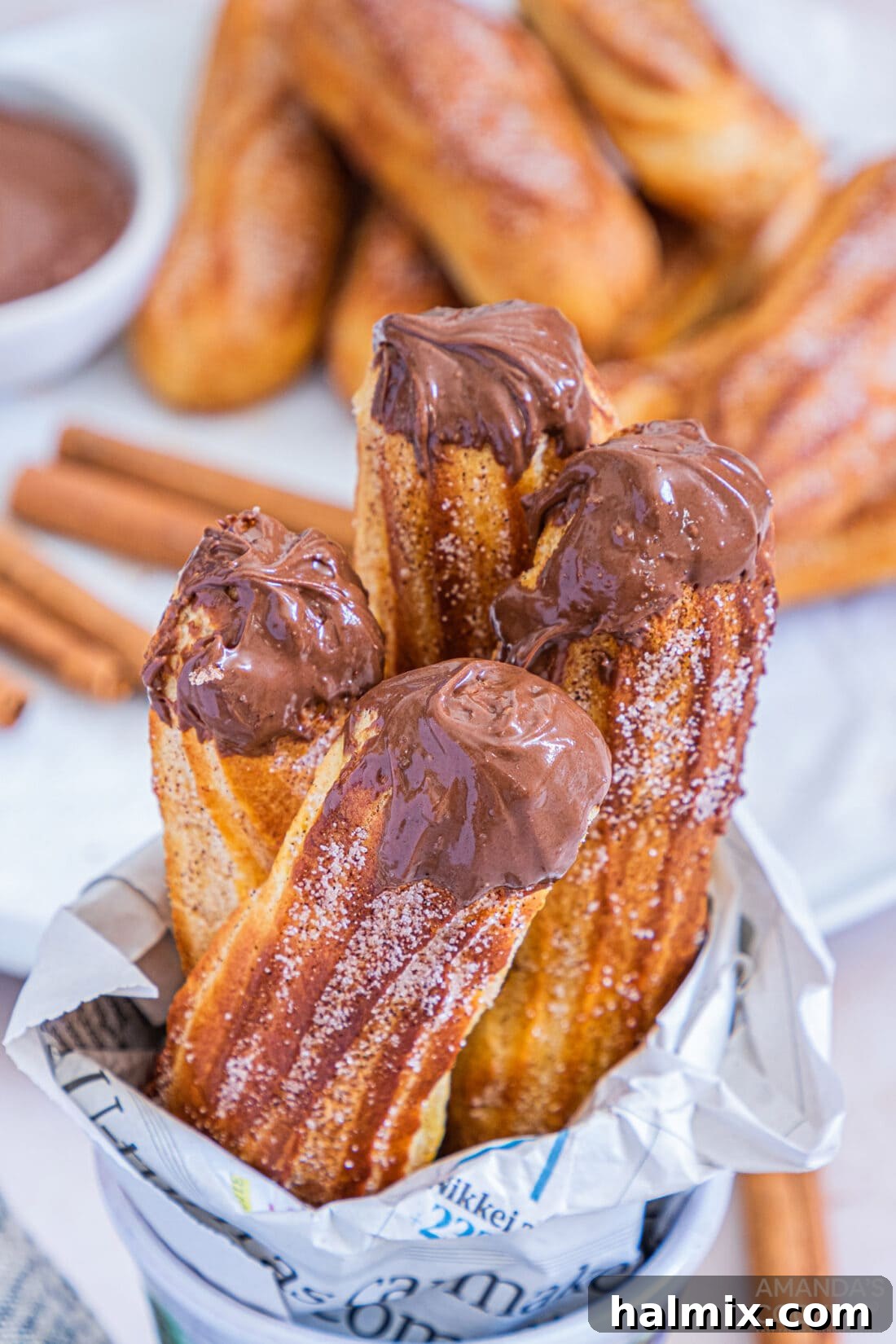 air fryer churros in a cup with chocolate nutella sauce