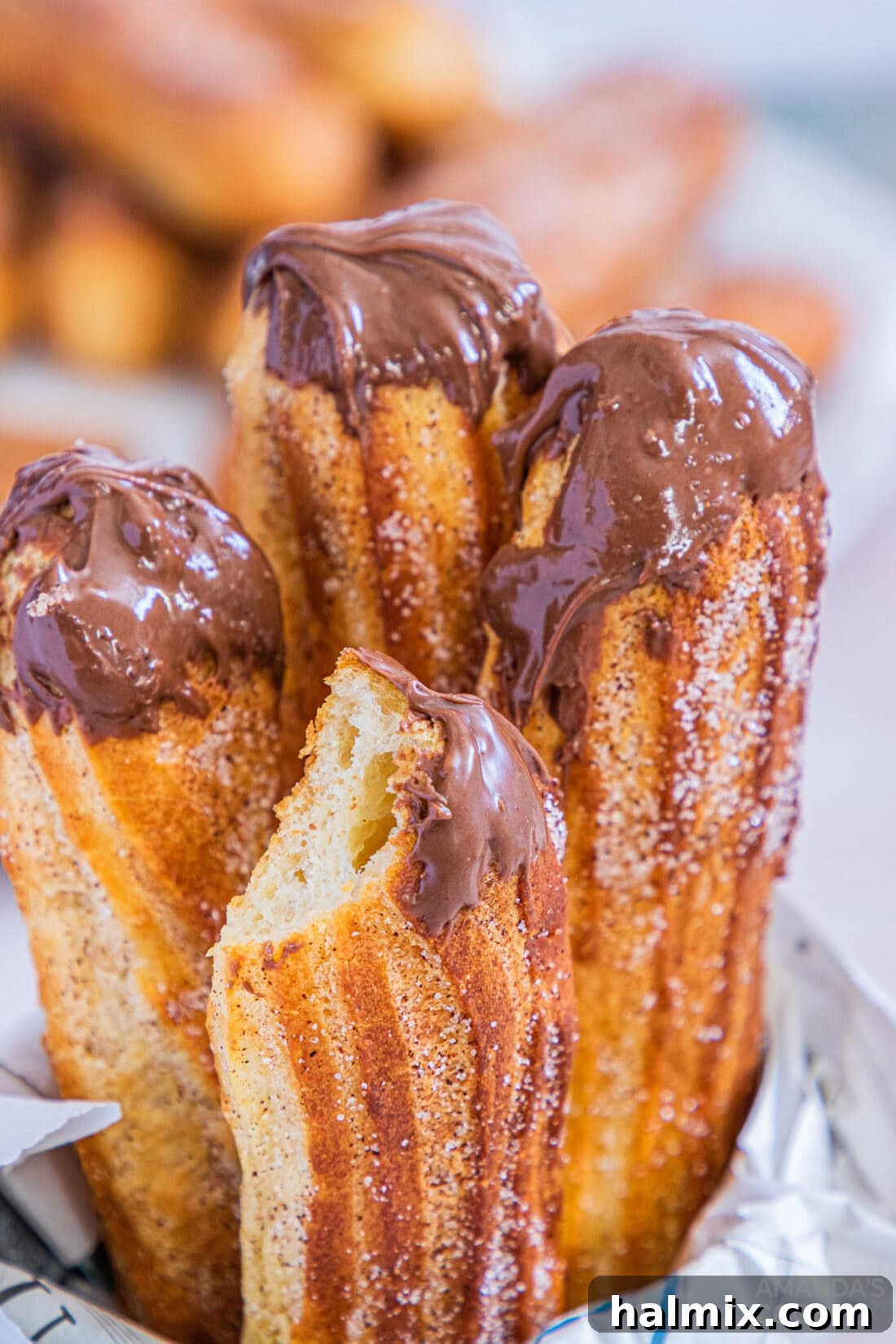 Air Fryer Churros with nutella sauce and a bit out of one of them