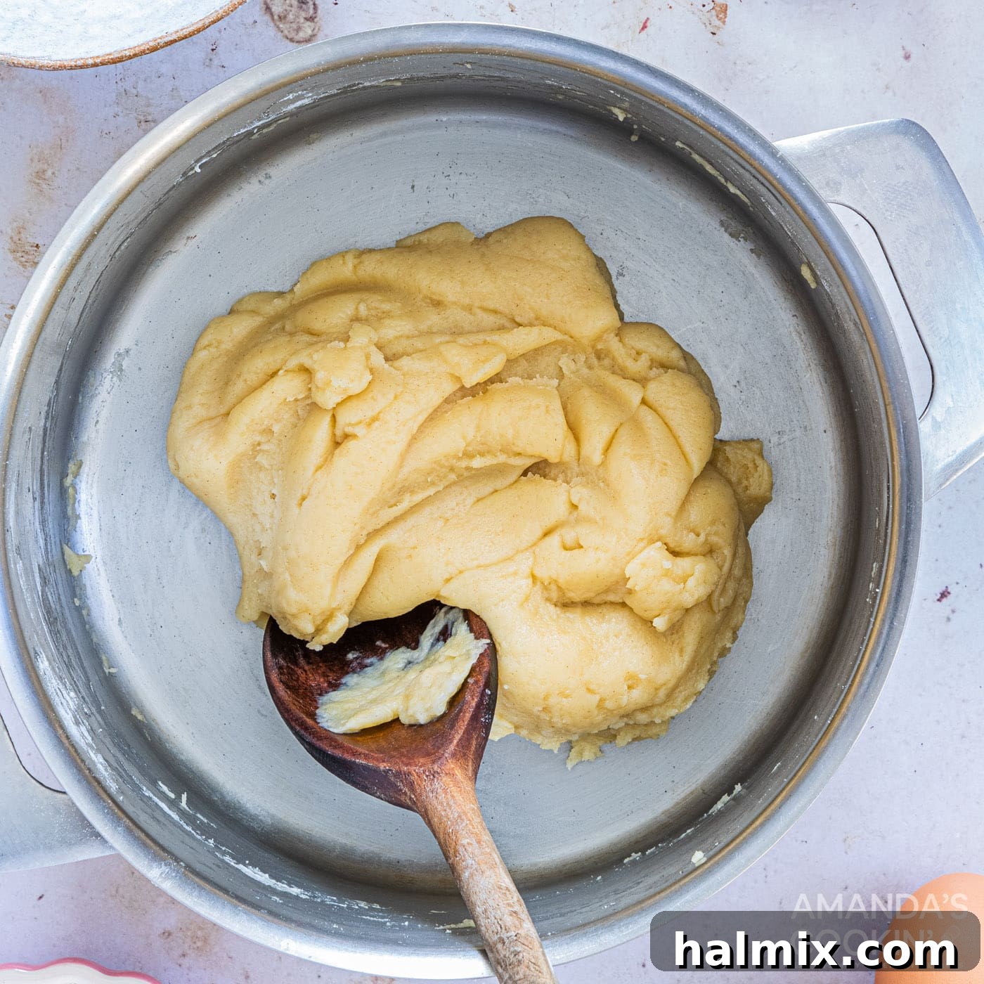stirring dough with wooden spoon