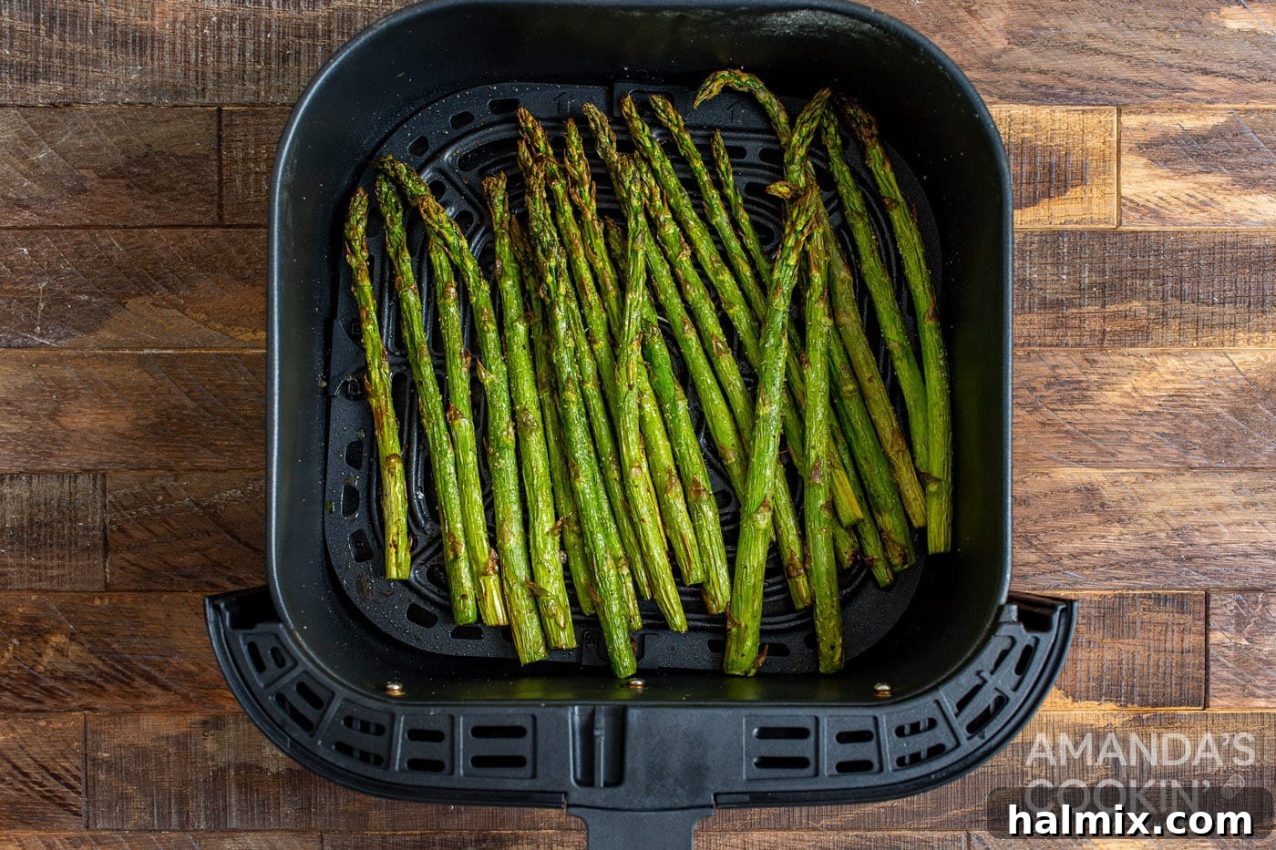 cooked asparagus in the air fryer basket after 9 minutes